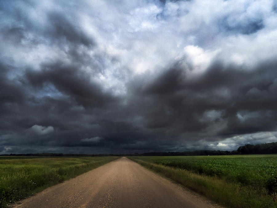 Riding into Dark Clouds Photograph by Eric Benjamin