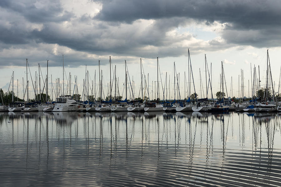 Ripples and Reflections - Ominous Gray Clouds at a Marina Photograph by Georgia Mizuleva