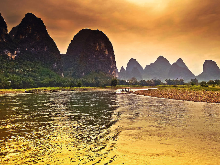Riverside scenery like gold-China Guilin scenery Lijiang River in Yangshuo Photograph by Artto Pan