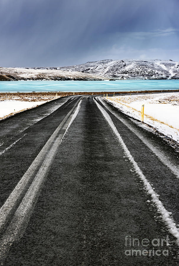 Road along frozen lake Photograph by Anna Om
