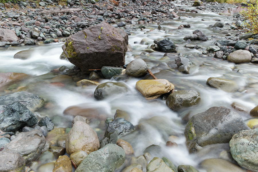 Rock in midstream Photograph by Jeff Swan