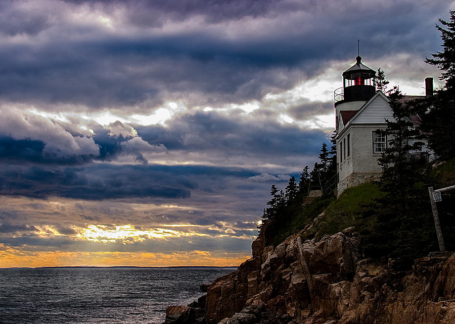 Rocky cliffs below Maine lighthouse Photograph by Jeff Folger