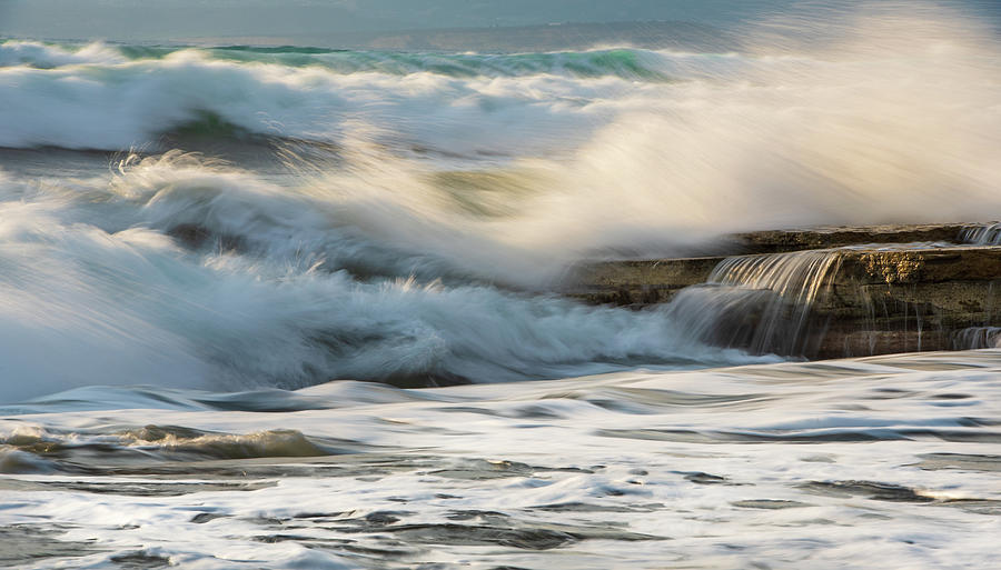 Rocky seashore, wavy ocean and wind waves crashing on the rocks Photograph by Michalakis Ppalis