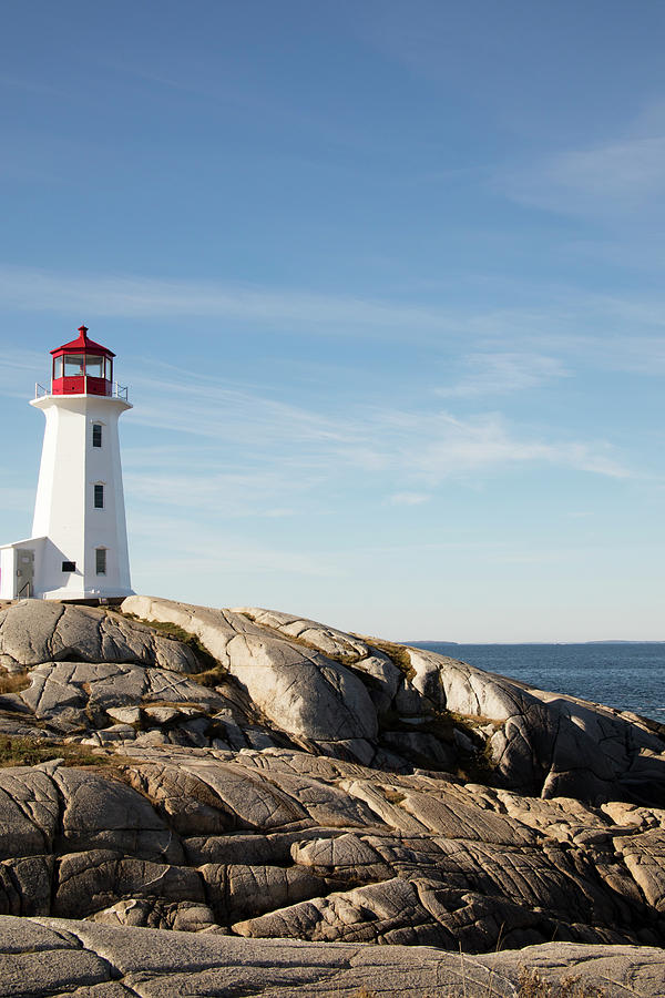 Rocky shoreline at Peggys Cove Lighthouse, Nova Scotia, Canada Photograph by Karen Foley
