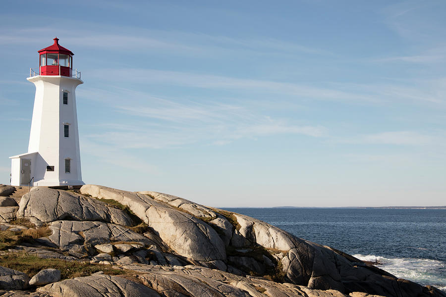 Rocky shores at Peggys Cove Lighthouse, Nova Scotia, Canada Photograph by Karen Foley