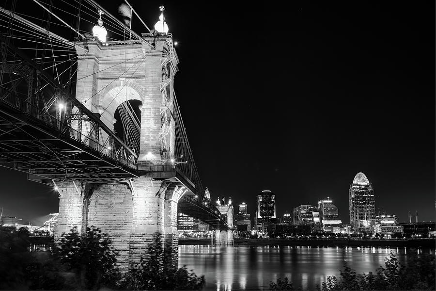 Roebling Bridge and Cincinnati Skyline at Night - Black and White Photograph by Gregory Ballos