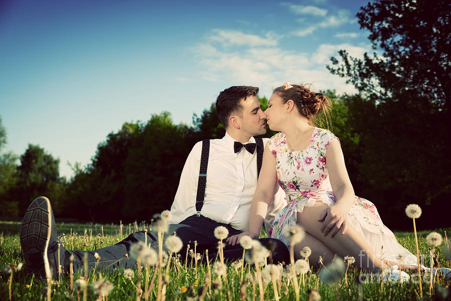 Romantic couple in love about to kiss sitting on grass Photograph by Michal Bednarek