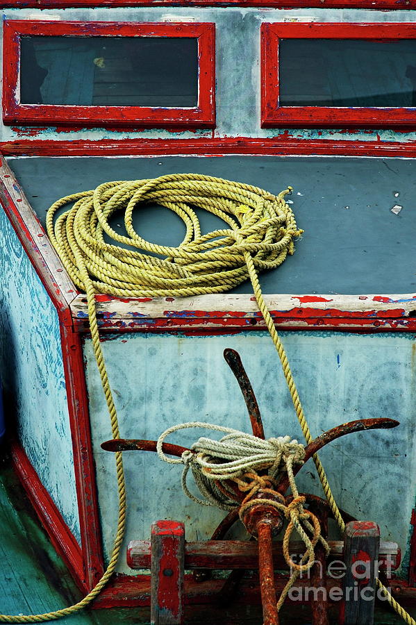 Ropes and rusty anchors on a boat deck Photograph by Sami Sarkis