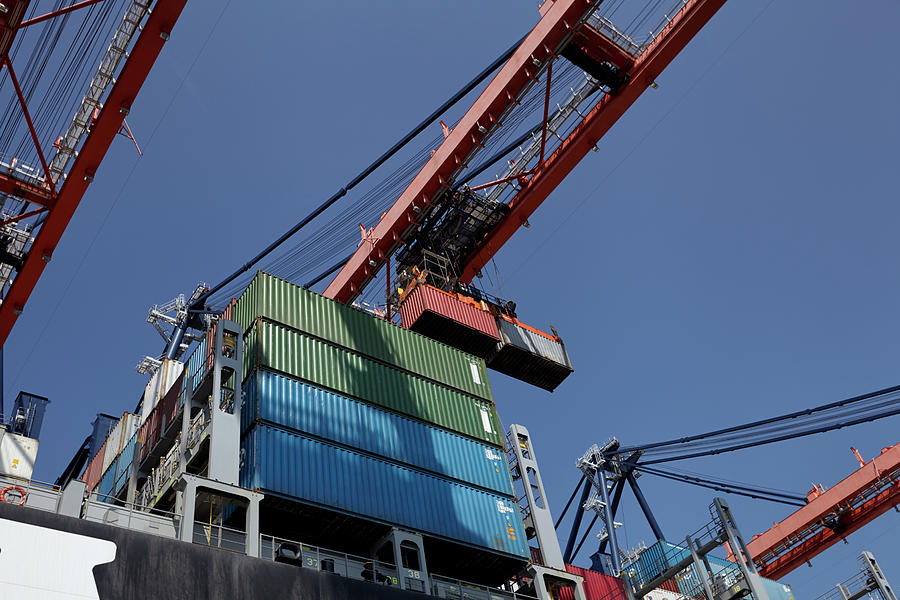 ROTTERDAM, NETHERLANDS. Large harbor cranes loading container ships in ...