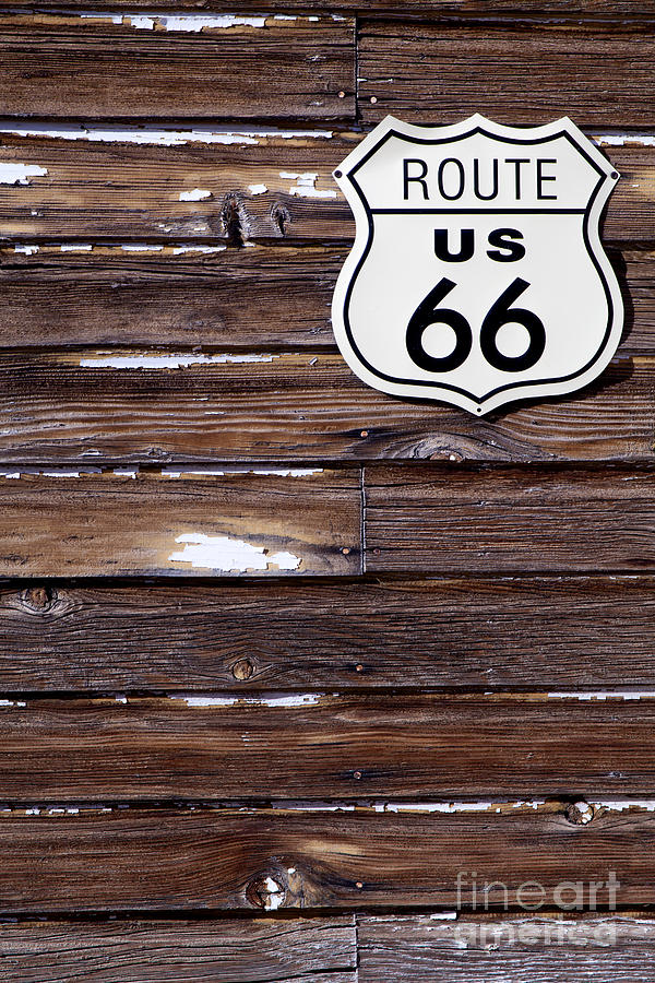Route 66 road sign on old wooden barn Photograph by Anthony Totah