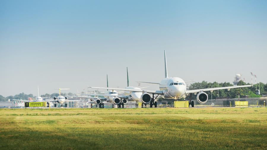 Winter Photograph - Row of airplanes ready to take-off by Alexandre Rotenberg