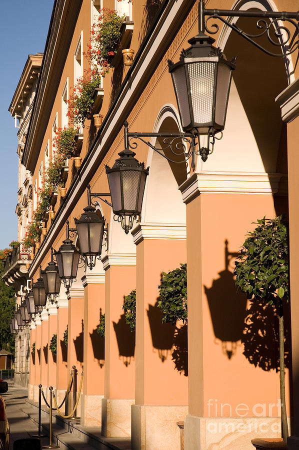 Row of lamps on columns of building  Photograph by Arletta Cwalina