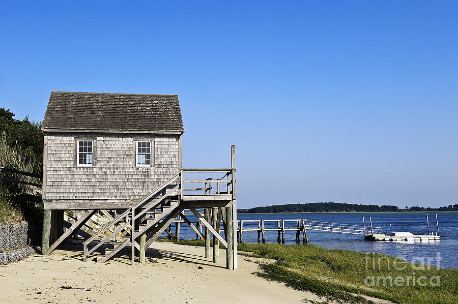 Rustic boathouse on the beach Photograph by John Greim