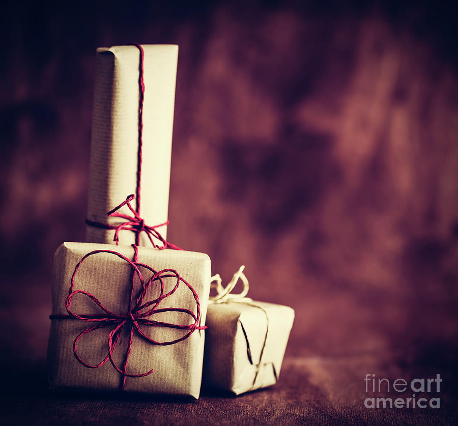 Christmas Photograph - Rustic retro gifts, present boxes on wooden background. Christmas time by Michal Bednarek