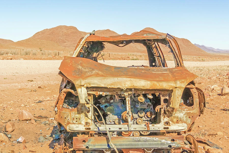 Rusty car in Nabimiam desert Photograph by Marek Poplawski