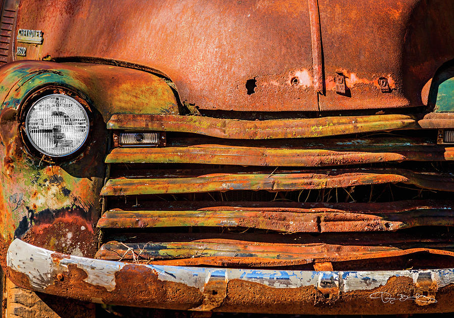 Rusty Old Car Sitting In A Junk Yard Photograph by Dan Barba