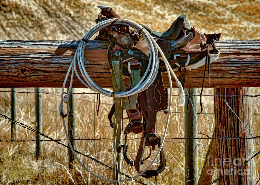 Saddle on an Idaho Fence Photograph by Priscilla Burgers