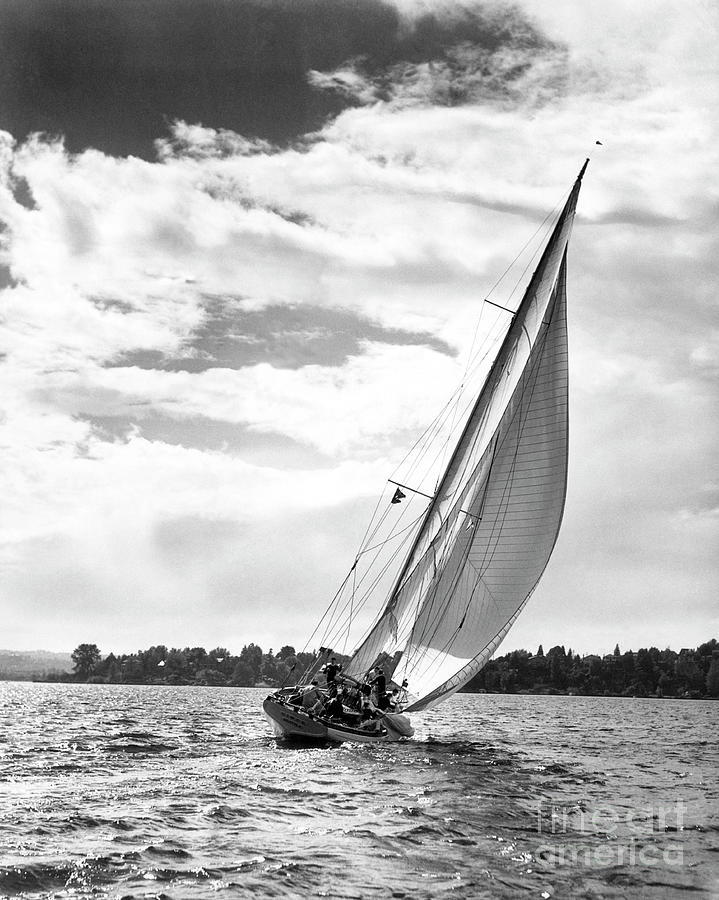 Sailboat off shore Photograph by Ewing Galloway