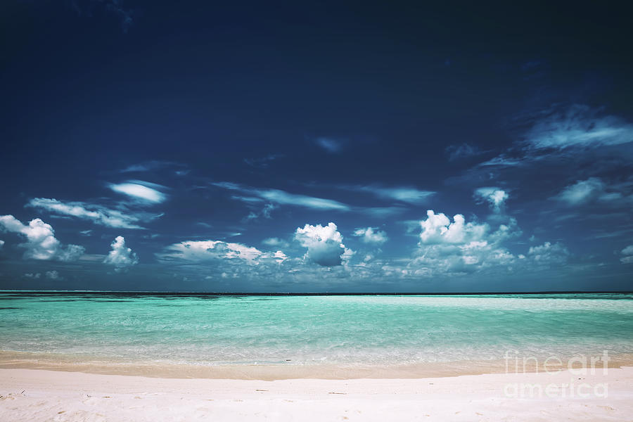 Sandy beach, clear see-through sea and blue sky. Photograph by Michal Bednarek