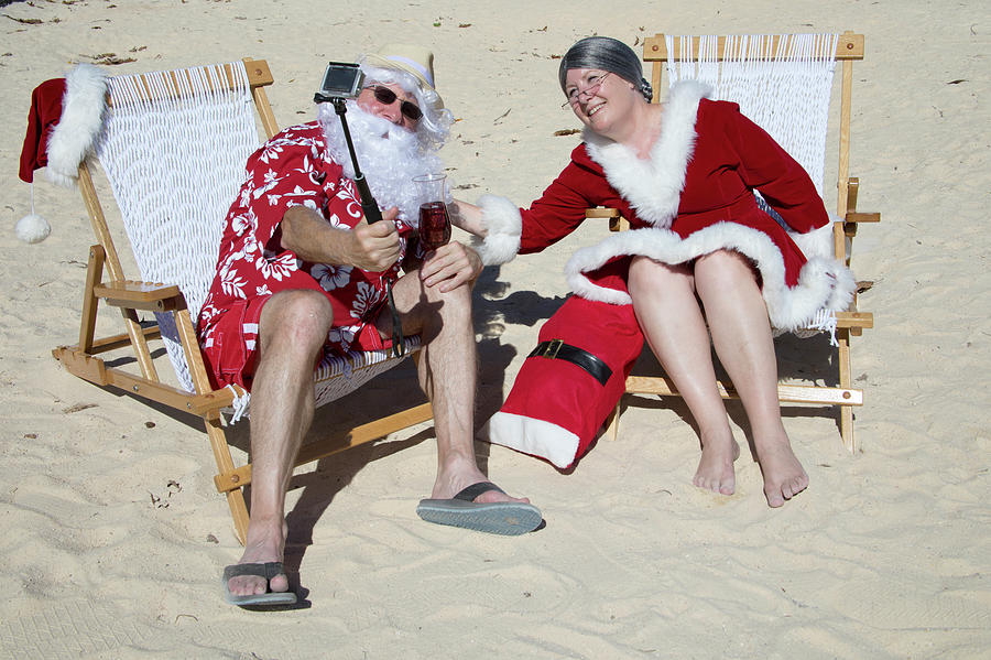 Santa and Mrs Claus taking selfie on beach Photograph by Karen Foley