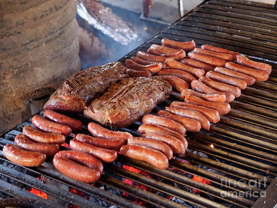 Sausages and beef on the grill at a traditional asado in Chile Photograph by Louise Heusinkveld