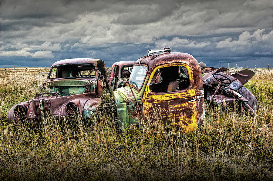 Scrapyard of Old Trucks Abandoned in a Prairie Field Photograph by Randall Nyhof