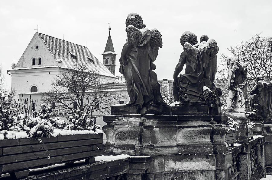 Sculptures of Cherubs in Loreta Complex. Snowy walk in Prague Photograph by Jenny Rainbow
