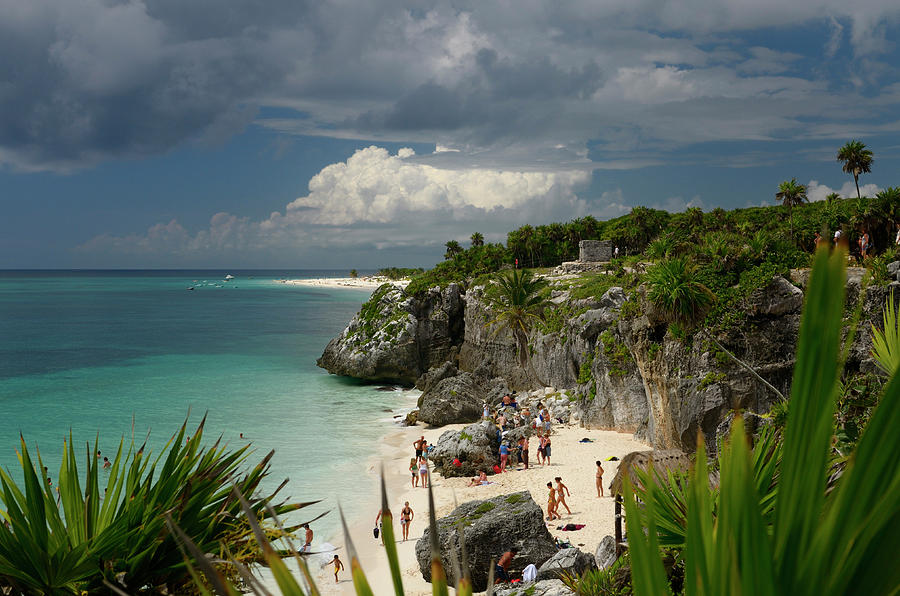 Sea cliff at Tulum Mexico with bathers on the beach and temple 5 ...