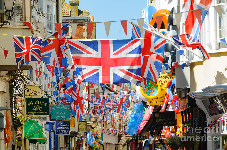 Seaside shops and flags Photograph by Colin Rayner