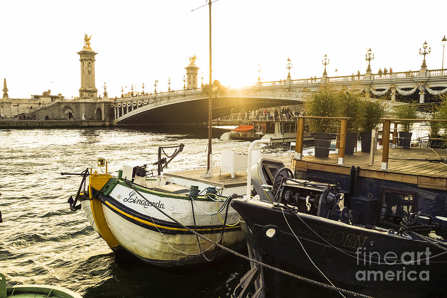 Seine river with barges and boats, Pont de Alexandre bridge behind, Paris France. Photograph by Perry Van Munster