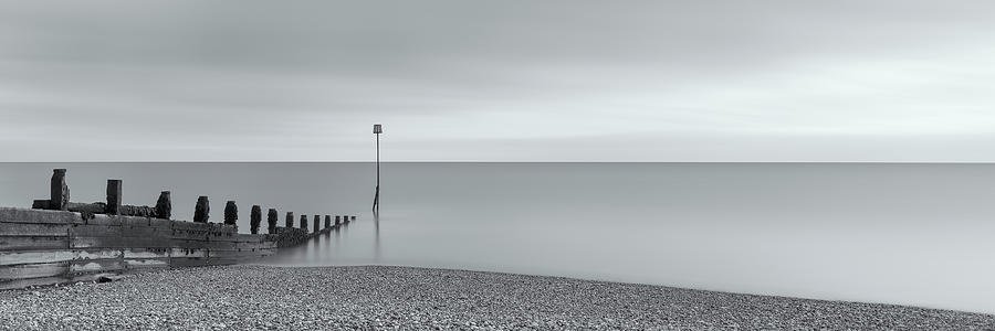 Selsey groyne on pebble beach in black and white Photograph by Angela ...