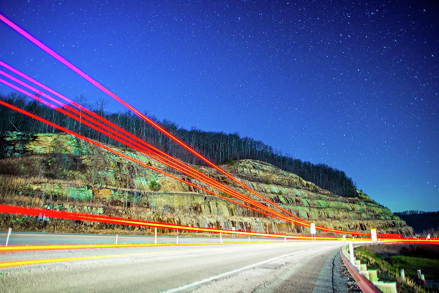 Semi And Car Trails On Highway Drving Through Mountains At Night Photograph by Alex Grichenko