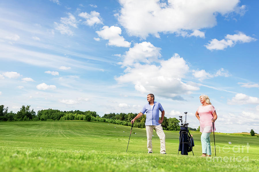 Senior couple enjoying golf game. Photograph by Michal Bednarek