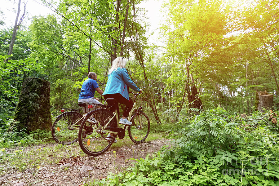 Senior couple enjoying their ride in the forest. Photograph by Michal Bednarek