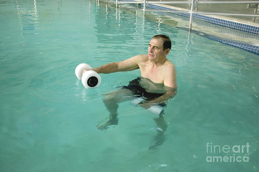 Senior Exercising In Pool Photograph by Inga Spence