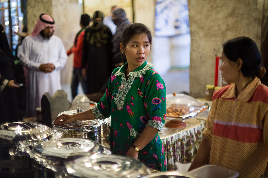 Serving food in Doha Souq Photograph by Paul Cowan