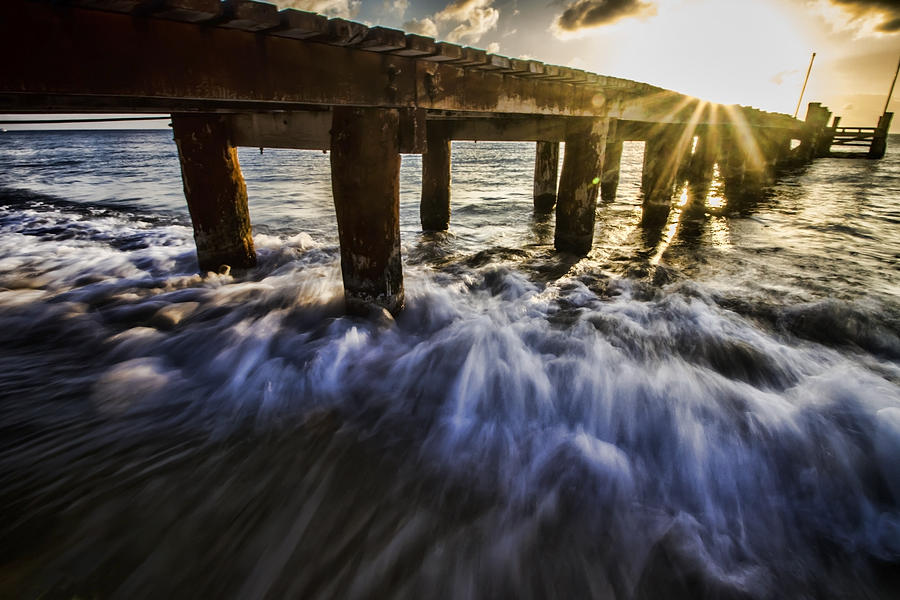 Setting Sun And Wave Action By A Pier Photograph by Sven Brogren