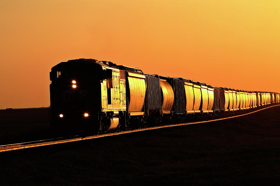 Setting sun reflecting off train and track Digital Art by Mark Duffy