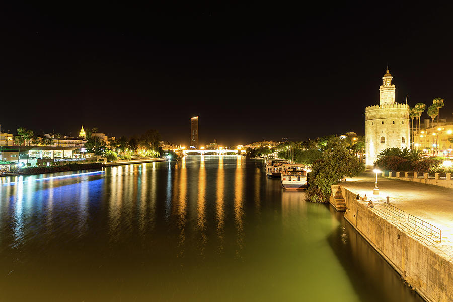 Torre Del Oro Photograph - Seville Night Magic - Torre del Oro and Guadalquivir River in Bright Gold by Georgia Mizuleva