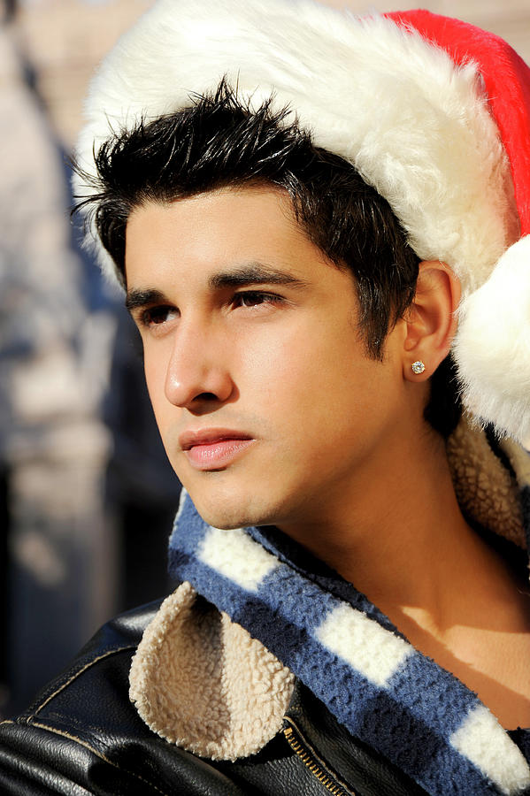 Sexy Santa portrait of a young hispanic man.   Photograph by Gunther Allen