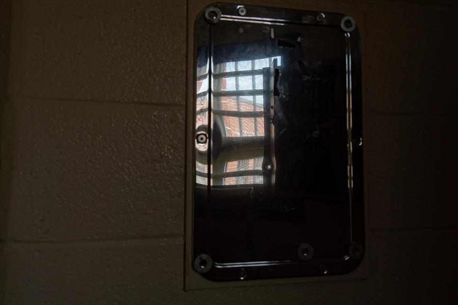 Shaving mirror reflecting bars on prison window Photograph by Karen Foley
