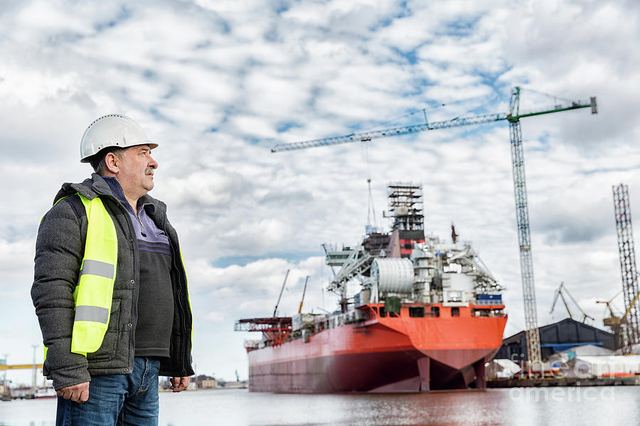 Shipbuilding engineer at the dockside in a port. Photograph by Michal Bednarek