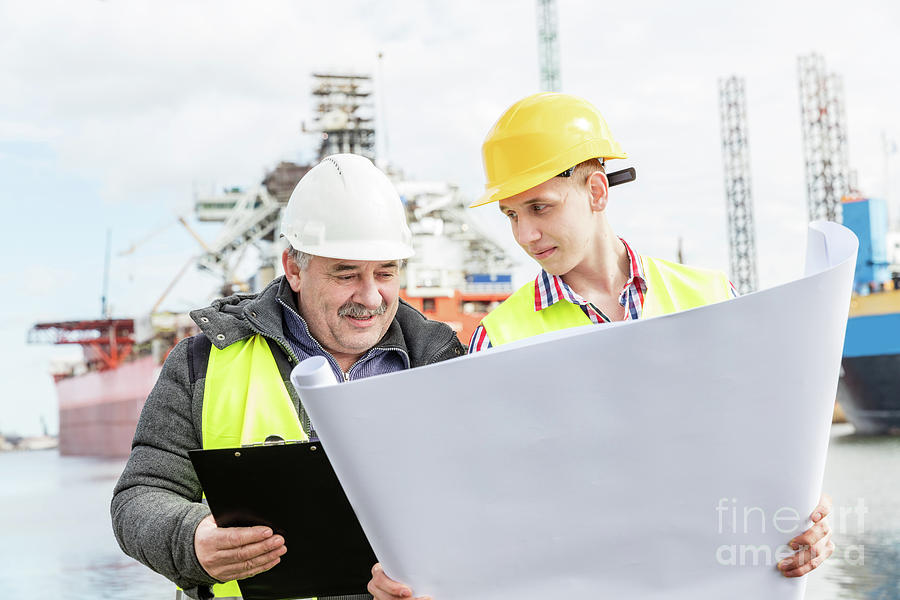 Transportation Photograph - Shipbuilding engineer explains technical matters with a student worker. by Michal Bednarek