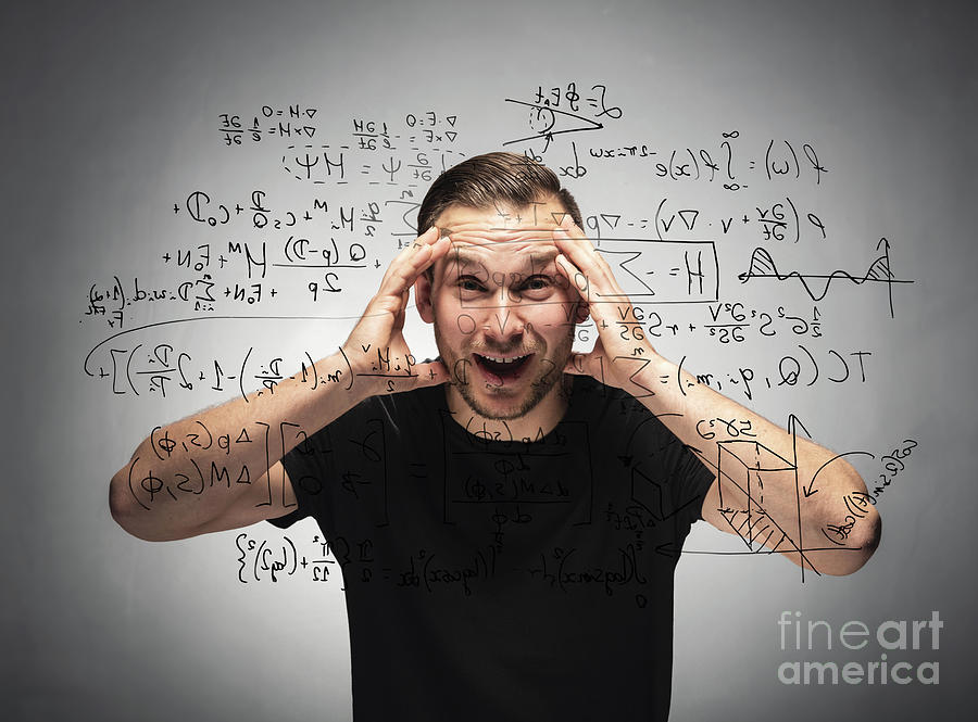 Shocked man looking at mathematical equation. Photograph by Michal Bednarek