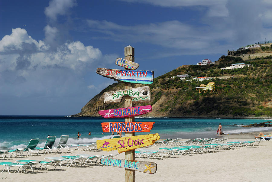 Sign Photograph - Signpost of Caribbean islands on the beach at St Maarten by Reimar Gaertner