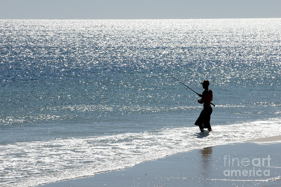 Silhouette of a man fishing Photograph by Anthony Totah