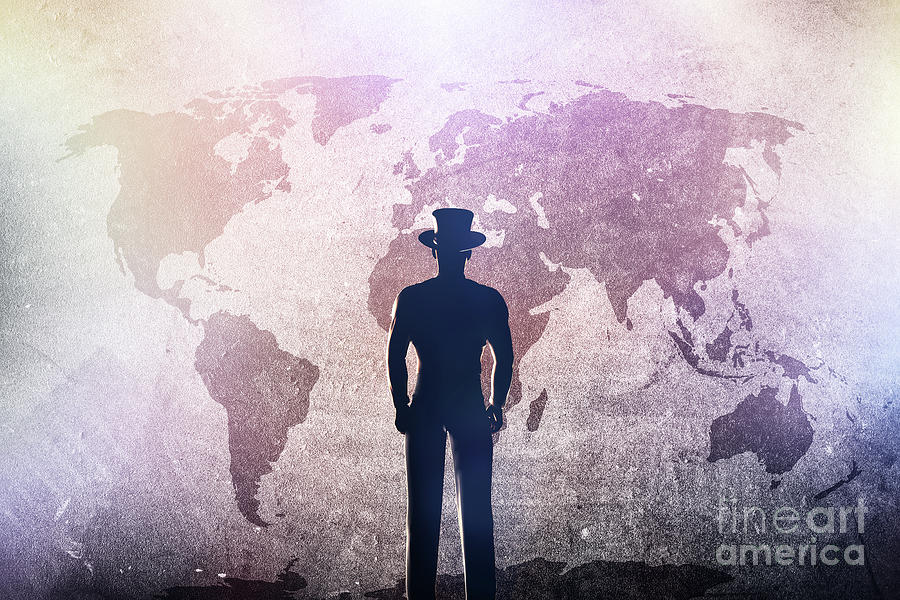 Silhouette of a man in hat standing in front of world map on grunge concrete wall Photograph by Michal Bednarek