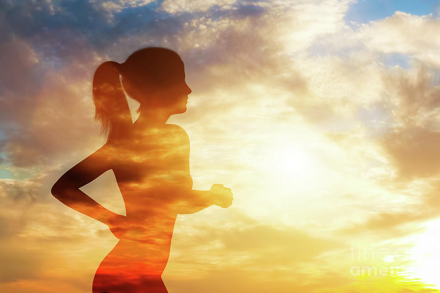 Silhouette of a running woman on sky background. Photograph by Michal Bednarek