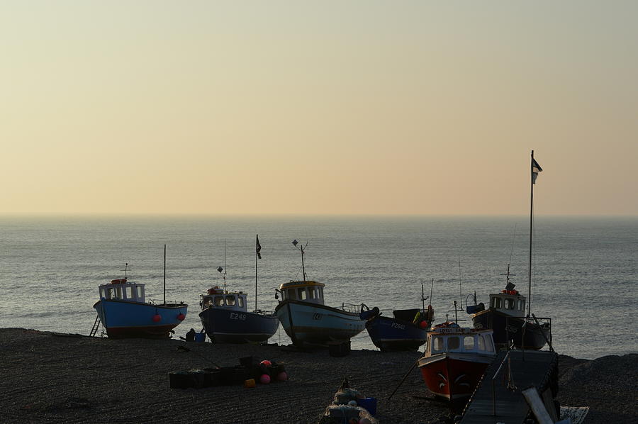 Silhouette of boats on beach  Photograph by Andy Thompson