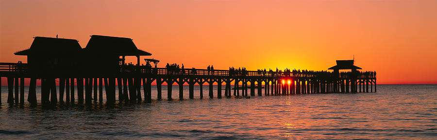 Silhouette Of Huts And A Pier At Dusk Photograph By Panoramic Images ...